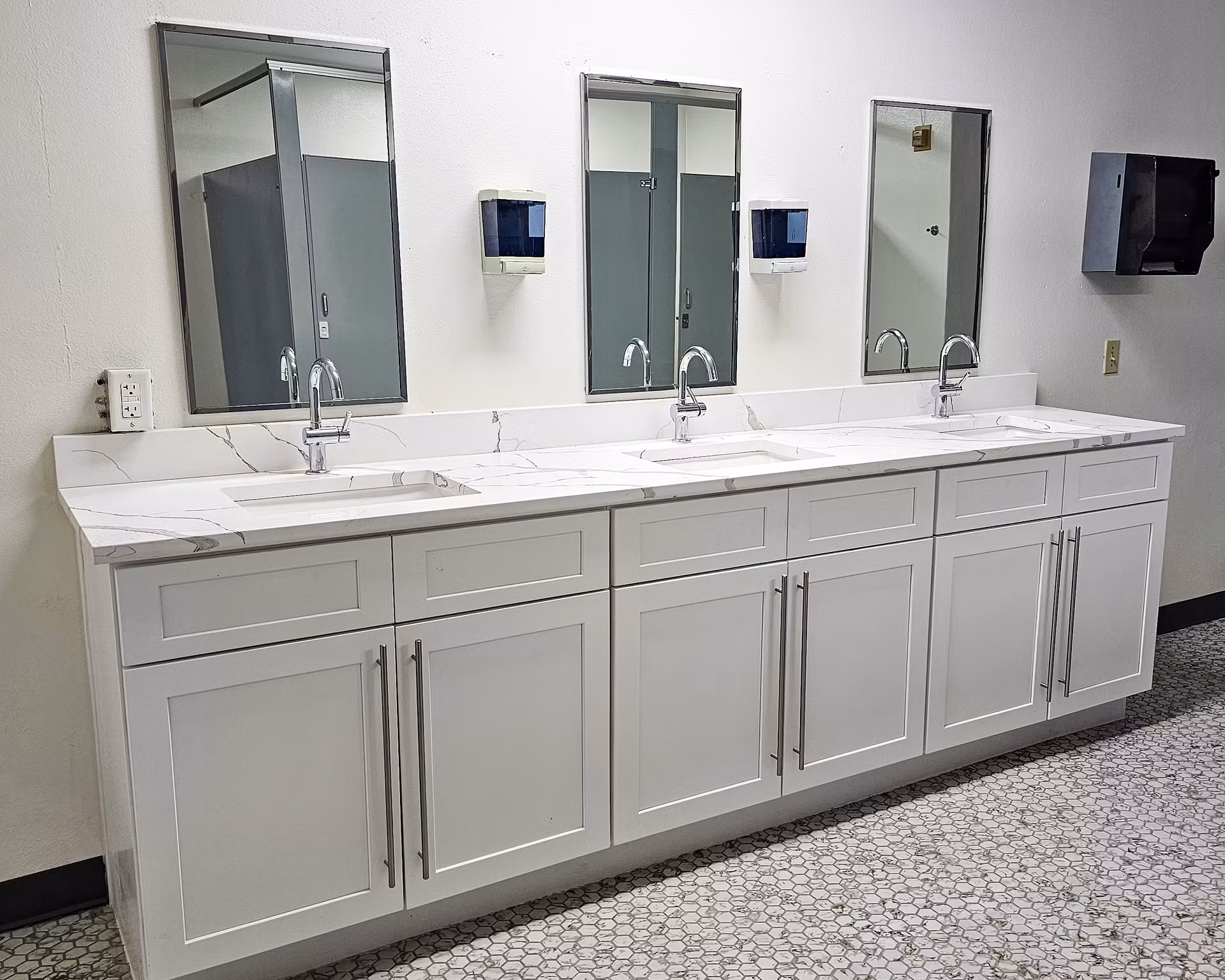 bathroom vanity with three sinks and mirrors