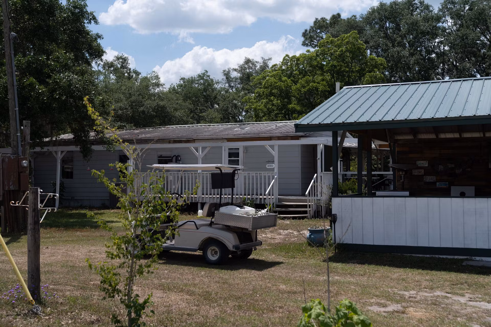 covered porch and a golf cart parked in front