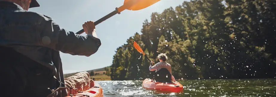 people enjoying kayaking on a lake or river