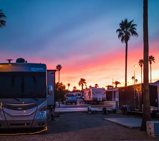 RVs parked near picnic spot during sunset